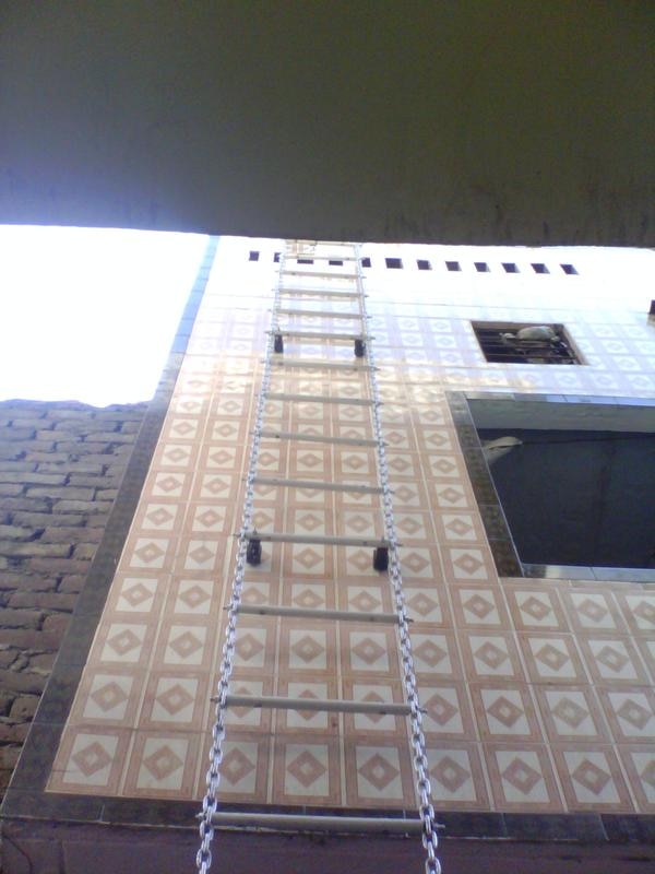AQPC LADDERS aluminum chain ladder is a lightweight, portable ladder made primarily of aluminum side rails and chain-linked steps (rungs). These ladders are commonly used for emergency escape, confined space entry, rescue operations, or access in difficult-to-reach places such as rooftops, tanks, silos, and construction scaffolds.Key Features:Lightweight & Durable: Made of corrosion-resistant aluminum, which makes it strong yet easy to carry.Flexible Design: The chain link design allows it to be rolled or folded for compact storage and transport.Non-slip Rungs: Often feature textured or knurled surfaces for better foot grip.Hook Attachments: May include top hooks or carabiners for quick attachment to fixed structures (e.g., windows, ledges, anchor points).Custom Lengths: Available in various lengths, depending on the application (e.g., 10 ft, 20 ft, 30 ft or more).Typical Applications:Emergency fire escape ladders for homes or buildingsEntry into confined spaces (e.g., manholes or tanks)Industrial or construction site accessMilitary or tactical use in rugged environments