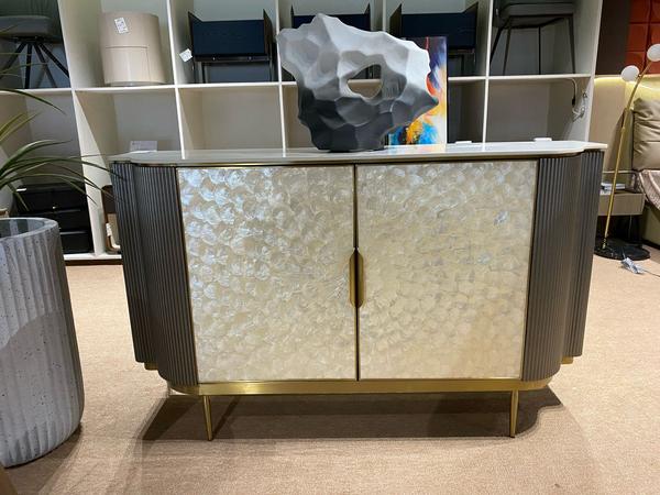 Experience elegance and functionality with this premium 2-door console cabinet sized at 1500x400x890mm. Crafted with a luxurious blend of stainless steel, natural shell, rock plate, and high-density board, this piece is a true statement of refined design. The materials not only ensure superior durability but also bring a rich visual texture to any space. Whether placed in an entryway, living room, or dining area, this cabinet offers both storage and style, making it a standout addition to your decor.