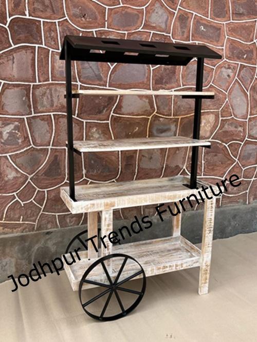 Whitewashed or lightly painted wooden frames with a deliberately worn, vintage feel.Canopy tops—often fabric or wood slats—adding height and visual interest.Large spoked or wooden wheels, which lend a nostalgic, hand-pulled cart charm.Well-crafted details like shelves, storage compartments, and display counters—ideal for décor or showcasing items.Perfect Impression (India) offers a charming Mini Wooden Cart Tray with Canopy—a decorative piece perfect for events, sweets displays, or personalized décor. Priced affordably at ₹16650, this is ideal for table styling or small-scale installations.