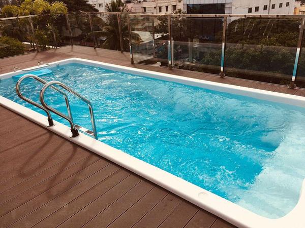 A readymade swimming pool is a pre-fabricated pool shell, typically made from materials like fiberglass or FRP (Fiberglass Reinforced Plastic), that is manufactured off-site and then delivered for quick installation, often in just a few days, whether above ground, in-ground, or partially in the ground.