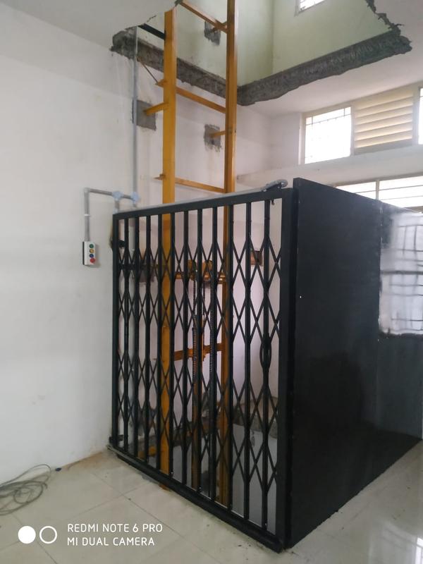 Being an eminent company, we are involved in offering Goods Lift in Ponnani, Kerala, South India.Top Goods Lift Manufacturers in Ponnani KeralaSmall Goods Lift Manufacturers in Ponnani KeralaGoods Lift Manufacturers in Ponnani Kerala Contact NumberHydraulic Goods Lift Manufacturers in Ponnani KeralaBest Goods Lift Manufacturers in Ponnani KeralaGoods Lift Manufacturers in Ponnani Kerala AddressWe are interested to supply our Goods Lift to Changanassery, Mattanur, Punalur, Nilambur, Cherthala, Sultan, Bathery, Maradu, Kottakkal, Taliparamba, Shornur, Pandalam, Kattappana, Cherpulassery, Mukkam, Iritty, Valanchery, Varkala, Nileshwaram, Chavakkad, Kothamangalam, Pathanamthitta, Attingal  in Kerala, South India. Goods Lift – DescriptionA Goods Lift (also known as a freight elevator or material lift) is a mechanical device designed to transport heavy materials, goods, equipment, and products between different floors in a building or facility. Unlike passenger lifts, goods lifts are specifically engineered to handle large, bulky, or heavy loads, often with reinforced platforms, higher weight capacities, and safety mechanisms.They can be powered by electric motors, hydraulic systems, or traction mechanisms, depending on the usage requirements and load capacity. These lifts are commonly used in industrial, commercial, and storage environments.Applications of Goods LiftWarehouses and Storage FacilitiesTransporting heavy boxes, pallets, and stock between floors.Factories and Industrial UnitsMoving machinery parts, raw materials, or finished goods safely and efficiently.Retail and SupermarketsShifting goods from storage areas to display sections.HospitalsHandling supplies, equipment, and medical inventory without interfering with patient movement.Hotels and RestaurantsTransferring food supplies, linens, and kitchen equipment between service areas.Construction SitesLifting tools, cement bags, and construction materials to different levels.Logistics and Distribution CentersStreamlining the flow of goods and improving turnaround time for loading and unloading.Benefits of Goods LiftImproved EfficiencyReduces time and labor required to move goods manually between floors.Enhanced SafetyMinimizes risks associated with carrying heavy loads, preventing accidents and injuries.Increased Load CapacityCan handle large, bulky items that are difficult to transport by hand or via stairs.Space OptimizationMakes vertical transport easier, freeing up floor space for other operations.Durability and ReliabilityBuilt to handle industrial conditions, making them robust and long-lasting.Cost-EffectiveReduces operational costs by lowering manpower requirements and improving productivity.Customizable DesignCan be tailored to meet specific load, space, and environmental requirements.Smooth OperationsHydraulic and electric lifts ensure steady and vibration-free transportation of goods.Hydraulic Goods LiftOperates using hydraulic cylinders powered by oil pressure.Suitable for low-rise buildings (usually up to 5 or 6 floors).Offers smooth operation and high load-bearing capacity.Requires less space for machinery compared to traction lifts.Traction Goods LiftUses steel ropes and counterweights to lift the platform.Powered by electric motors.Suitable for medium to high-rise buildings.Offers faster speeds and higher efficiency.Chain Hoist Goods LiftUses chain mechanisms along with pulleys for lifting.Suitable for handling moderate loads.Compact design, commonly used in workshops or smaller industries.Rack and Pinion Goods LiftUses a gear system for vertical movement.Known for safety and stability, especially in environments where sway and tilt must be minimized.Often used in heavy-duty industrial settings.Pneumatic Goods LiftPowered by compressed air systems.Suitable for lightweight loads.Requires less maintenance and is ideal where hydraulic systems are not feasible.Vertical Reciprocating Conveyor (VRC)A type of goods lift designed specifically for repetitive transport of materials.Often used in manufacturing plants, retail centers, and warehouses.Custom or Modular Goods LiftDesigned according to specific industrial or architectural needs.Can include features like automated doors, remote controls, or explosion-proof materials depending on the environment.Choosing the Right TypeLoad Capacity: Heavy loads – hydraulic or traction lifts; lighter loads – pneumatic or chain hoist.Building Height: Low floors – hydraulic; high floors – traction.Space Constraints: Hydraulic systems need less headroom; traction systems need more.Maintenance & Budget: Pneumatic lifts have simpler maintenance, while traction lifts offer efficiency at higher costs.Safety Features of Goods LiftsOverload ProtectionPrevents operation when the load exceeds the maximum capacity.Protects the lift from damage and ensures user safety.Emergency Stop ButtonAllows the operator to halt the lift immediately in case of emergencies.Safety InterlocksEnsures that doors or gates cannot be opened unless the lift is at the correct level.Limit SwitchesStops the lift at predefined points to avoid over-travel or mechanical failure.Brake SystemsAutomatic brakes engage during power failure or emergency, preventing the lift from falling.Alarm SystemsAlerts operators if there is a malfunction or irregularity during operation.Non-Slip FlooringEnsures goods stay in place during transportation and reduces the risk of accidents.Protective EnclosuresPrevents access to moving parts and reduces the chances of injury.Fire Safety MeasuresSome lifts are equipped with fire-resistant panels and emergency ventilation systems.Backup Power SupplyAllows the lift to be operated temporarily during power outages.Maintenance Tips for Goods LiftsRegular InspectionsCheck the mechanical parts, wiring, and hydraulic systems at regular intervals.LubricationKeep moving parts well-lubricated to reduce wear and tear and prevent overheating.Test Safety SystemsPeriodically test the overload sensors, brakes, and limit switches to ensure they function properly.CleanlinessKeep the lift clean and free from dust, debris, or oil that may affect its performance.Monitor Load PatternsAvoid sudden heavy loads or uneven weight distribution to prevent strain on the lift.Professional ServicingHire certified technicians for periodic servicing and repairs.Check Hydraulic Fluids or Pneumatic SystemsEnsure fluid levels and air pressure are within recommended levels for efficient operation.Keep RecordsMaintain logs of inspections, repairs, and maintenance for accountability and troubleshooting.Training for OperatorsTrain personnel to operate the lift safely and respond to emergencies correctly.Replace Worn PartsPromptly replace damaged cables, chains, seals, or brakes to avoid breakdowns.