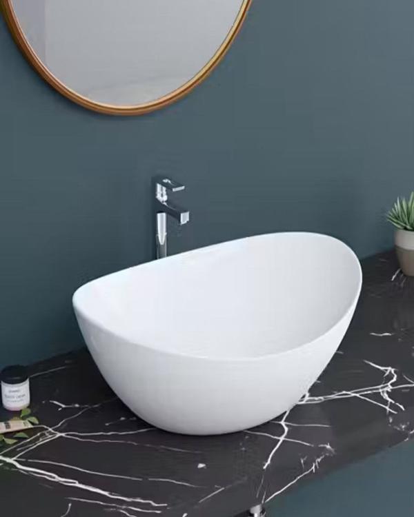 TABLE TOP WASH BASIN OVAL SHAPED DESIGNPremium ceramic with a Glossy Finish for Durability and Easy Maintenance. Suitable for both residential and commercial bathrooms.Deep design to prevent splashing.