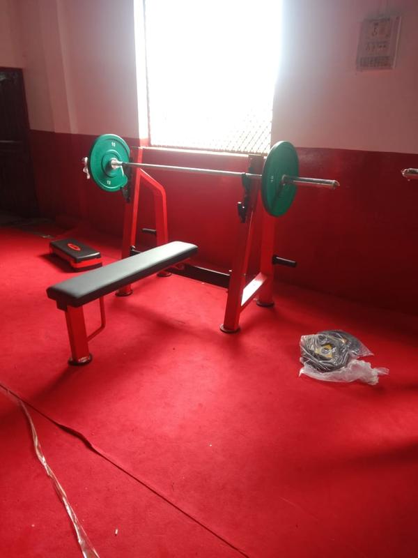 An Olympic flat bench is a sturdy, stable piece of gym equipment with a flat, padded surface, designed for heavy barbell and dumbbell chest, shoulder, and triceps exercises like the bench press, featuring integrated racks for an Olympic bar, safety catches, and often a spotter platform, built with a robust steel frame for high weight loads and durability in commercial or home gyms. 
