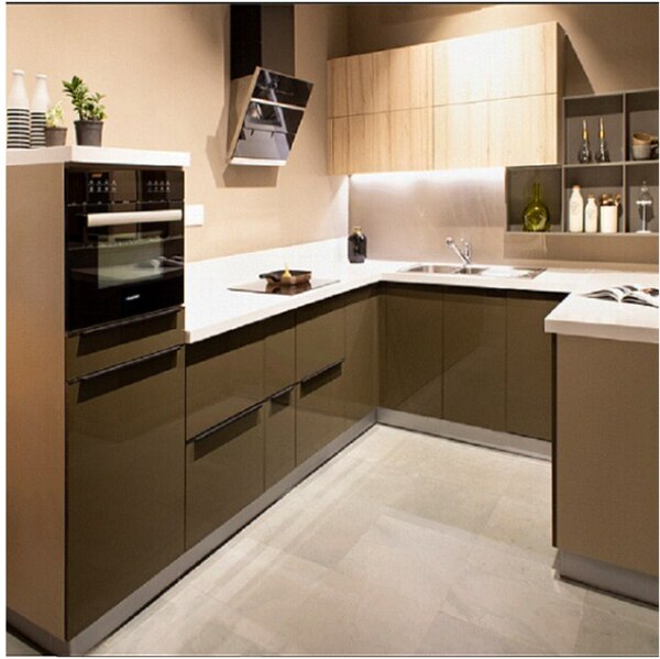 This U type kitchen with appliances loded like induction , oven , dishwasher , chimney creates extra time for the lady to explore her hobbies .the coffee acrylic base shutters with a combination of synchro finish laminate on the wall is a unique combination that is a bold attempt for people who like dark colors.