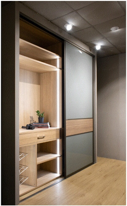 This floor to ceiling wardrobe is tall dark and handsome. Sliding doors are in back painted glass