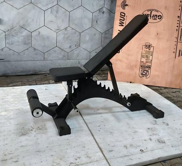 Construction and Durability: It features a sturdy steel frame designed to support heavy lifting and provide stability. The equipment is built for durability, with some models featuring a rust-free coating. Comfort: High-density foam padding is used throughout the bench, providing a soft yet firm surface to reduce muscle fatigue during full-body workouts. Adjustability and Versatility: The bench offers multiple adjustable positions for both the seat and backrest, allowing for a wide range of exercises including incline, flat, and decline bench presses, as well as shoulder presses and various core workouts. Functionality: It is suitable for strength training, bench presses, and dumbbell exercises. The design may also include built-in leg rollers for leg exercises. Usage and Space: Its compact design makes it ideal for both home and commercial gym settings, especially where floor space is limited. 