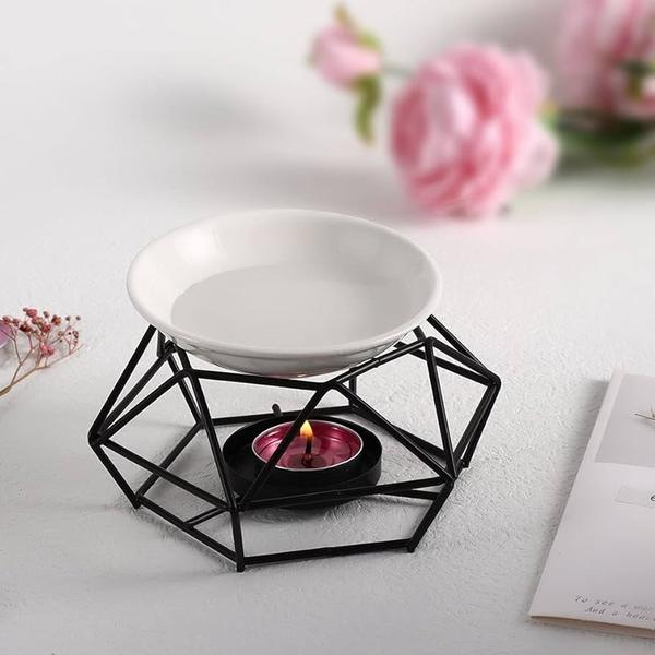 The Aroma Oil Burner with Geometric Rack Design is a stylish and functional décor piece, perfect for enhancing the ambiance of bathrooms and living spaces. Featuring a modern geometric frame and a heat-resistant bowl, it gently diffuses soothing fragrances using a candle flame. Its elegant design creates a warm, relaxing atmosphere while also serving as a decorative candle holder. Compact, durable, and easy to use, it is ideal for aromatherapy, odor control, and adding a touch of sophistication to any space.