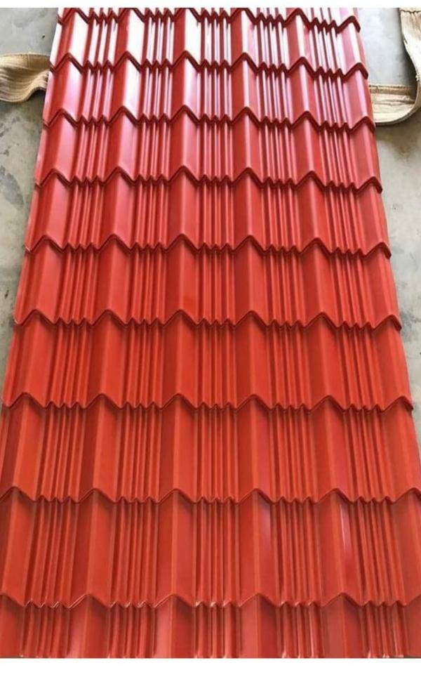 Colour Tile Profile Sheets are aesthetically designed roofing sheets that combine the classic appearance of traditional roof tiles with the strength and durability of modern metal sheets. These sheets are widely used for residential, commercial, and industrial roofing where visual appeal and long-lasting performance are required.Key FeaturesElegant tile-like design with modern finishHigh strength and durabilityउत्कृष्ट weather and corrosion resistanceUV-resistant color coatingLightweight and easy to installLeak-proof overlapping systemLow maintenance and long lifeAvailable in multiple attractive colorsTechnical SpecificationsParameter	SpecificationBase Material	Pre-Painted Galvanized Iron (PPGI) / Galvalume SteelCoating Type	Color Coated (PE / SMP / PVDF)Sheet Thickness	0.30 mm – 0.60 mmEffective Width	1000 mm – 1100 mmLength	Customizable (up to 12 meters)Profile Type	Tile Profile (Step Tile / Spanish Tile Design)Coating Thickness	15–25 microns (top), 5–10 microns (back)Zinc/Aluzinc Coating	80 GSM – 150 GSMColor Options	Brick Red, Terracotta, Blue, Green, Grey, Custom RAL ColorsSurface Finish	Glossy / Matte / TexturedTensile Strength	250 – 550 MPaCorrosion Resistance	High (depends on coating quality)Water Tightness	Leak-proof with proper overlapTemperature Resistance	Suitable for all weather conditionsWeight	Approx. 3 – 6 kg/m²Available VariantsStep Tile Profile SheetsSpanish Tile Profile SheetsStone Coated Tile Sheets (Optional finish)ApplicationsResidential houses and villasFarmhouses and resortsCommercial buildingsIndustrial shedsParking sheds and garagesRoofing renovation projectsAdvantagesAttractive appearance similar to traditional tilesFaster installation compared to clay tilesDurable and long-lasting coatingCost-effective roofing solutionResistant to cracking, warping, and corrosionSuitable for all climatic conditionsOptional AccessoriesRidge caps and hip coversValley gutters and flashingSelf-drilling screws with EPDM washersSealants and waterproofing accessoriesWhy Choose Yogeshwar Profile Industries?Premium quality color-coated sheetsAdvanced roll-forming technologyCustom design and size optionsStrict quality control standardsReliable supply across India