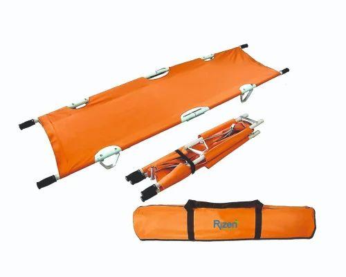 To use the orange rescue stretcher shown in the image, follow these steps:1. *Unroll and unfold*: Take the rolled stretcher (bottom image) and unroll it to its full length (top image). Ensure the fabric is flat and the metal handles are accessible.2. *Position the patient*: Place the injured person on the stretcher, aligning their body centrally for balanced support.3. *Secure the patient*: Use the straps or buckles (visible on the folded version in the middle) to fasten the patient safely onto the stretcher, preventing movement during transport.4. *Lift and transport*: Grip the metal handles on both ends and lift the stretcher with assistance if needed. Carry the patient to a safe location or ambulance for further care.5. *Fold for storage*: After use, fold the stretcher (as shown in the middle image) and secure it with straps, then roll it into the compact carrying bag (bottom image) for easy storage or transport.Need details on specific safety precautions or certifications for this stretcher model?