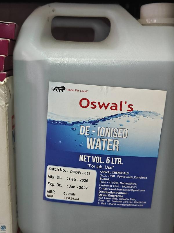 The image shows a 5-litre white plastic bottle of *Oswal's De-Ionised Water* with the following details on the label:1. *Batch No.* – OCDW – 0032. *Manufacturing Date* – February 20223. *Expiry Date* – January 2023 (the product has expired).4. *MRP* – ₹2505. *Manufacturer* – Oswal Chemicals, Yewlewadi, Kondhwa, Pune, Maharashtra.De-ionised water is typically used for laboratory purposes (as indicated by “For lab. Use”).Need anything specific about its usage or sourcing?