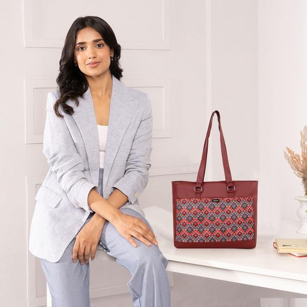 Upgrade your everyday style with this elegant and functional women’s tote handbag, designed for modern lifestyles. Crafted with premium vegan leather and beautifully handcrafted fabric, this bag blends durability with eye-catching aesthetics. The vibrant patterned exterior paired with a sleek solid top adds a sophisticated yet trendy touch—perfect for work, shopping, or casual outings.Designed with practicality in mind, this handbag features a spacious main compartment that comfortably fits your daily essentials like notebooks, tablet, wallet, and more. Inside, you’ll find a secure internal zipper pocket to keep valuables safe and organized. The back zip pocket allows quick access to frequently used items like your phone or keys, while the additional external zipper pockets enhance storage convenience.The sturdy zipper closure ensures everything stays secure, while the water-resistant inner lining protects your belongings from accidental spills. With strong dual shoulder straps, this bag offers comfortable carrying throughout the day without compromising on style.Lightweight yet durable, this tote is ideal for women who need a reliable everyday bag with a fashionable edge. Whether you're heading to the office, college, or a casual day out, this handbag delivers the perfect balance of utility and elegance.