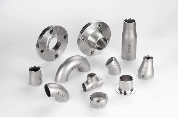 The provided image outlines the technical specifications for industrial Buttweld Fittings, which are designed to create permanently welded, leak-proof piping networks with smooth fluid flow.## ⚙️ Technical Specifications## Sizing & Dimensional Standards* Standards: ANSI B16.9 and MSS SP-43.* Size Range: 1/4“ NB to 80” NB (Available in both Seamless and ERW / Welded options).* Wall Thicknesses: SCH 5S, SCH 10S, SCH 20S, SCH 40S, SCH 80S, SCH 120S, SCH 160S, and SCH XXS.------------------------------## 📋 Material Specifications & Design Standards## 1. Stainless Steel (Corrosion Resistance)* Standard: ASTM A403* Grades: WP304, 304L, 304H, 310, 310S, 316, 316L, 316Ti, 321, 309, 347, and 904L.## 2. Carbon Steel (High Pressure & Low Temperature)* Standard Grades:* ASTM A234 WPB (Standard high-temperature/pressure service).   * ASTM A420 WPL3 / WPL6 (Engineered for low-temperature impact strength).## 3. Alloy Steel (Power Plant & Boiler Application)* Standard: ASTM A234* Grades: WP1, WP5, WP9, WP11, WP22, and WP91.* Compliance: Available in both IBR (Indian Boiler Regulations) and Non-IBR categories.## 4. Nickel & Exotic Alloys (Extreme Environments)* Materials: Monel, Inconel, Hastelloy, Pure Nickel, Cupro Nickel, Titanium, Duplex, and Super Duplex.------------------------------## 📐 Product Types & Component Categories* Elbows: Long Radius (LR) and Short Radius (SR) profiles in 45°, 90°, and 180° configurations to change flow direction.* Tees: Equal Tees (uniform branch sizes) and Unequal/Reducing Tees (smaller branch line).* Stubends: Short Neck and Long Neck Stubends designed for use with lap joint backing flanges.* Reducers: Concentric Reducers (symmetrical centerline) and Eccentric Reducers (flat on one side for horizontal piping).* End Closures & Junctions: Pipe End Caps (seals a pipe line permanent end) and Crosses (4-way intersections).------------------------------If you are coordinating a pipeline layout, let me know if you would like to compare Concentric vs. Eccentric reducer applications, review the wall thickness dimensions for a specific schedule, or check local sourcing availability in Ahmedabad. How would you like to proceed?