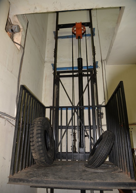 We Are Hydraulic Goods Lift Manufacturers @locationMain Features :- Heavy load handling capacity (500 kg to 25 tons+)Smooth and jerk-free operationLow maintenanceCompact designCustom platform sizesPit-mounted or pit-less installationManual or automatic controlsSafety interlock doors and emergency stop systemsCommon Applications :- Warehouses & distribution centersManufacturing plantsAutomobile workshopsShopping malls & supermarketsPharmaceutical & food industriesHotels & hospitalsAdvantages :- Efficient movement of heavy goodsReduced manual laborImproved workplace safetyEnergy-efficient operationSuitable for limited spacesLower installation cost compared to traction liftsTypes of Hydraulic Goods LiftsSingle Mast LiftDouble Mast LiftWall Mounted LiftCage Type Goods LiftScissor Lift PlatformGoods Lift with Attendant