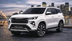 The Toyota Fortuner Legender is a premium, rugged 7-seater SUV distinguished by its aggressive catamaran-style front bumper, split quad-LED headlamps, and dual-tone roof. Available in 4x2 and 4x4 powertrain configurations, it is highly sought after for its powerful performance and luxury cabin appointments.Performance & SpecificationsThe Legender delivers robust power for both city streets and tough terrains:Engine: 2.8-liter (2755 cc) 4-cylinder turbo-diesel; also available with a 48V mild-hybrid setup for enhanced efficiency.Output: 204 PS (150 kW) maximum power.Torque: 500 Nm (Automatic), 420 Nm (Manual).Transmission: 6-speed Automatic with sequential shift, paddle shifters, and shift lock.Dimensions: 479.5 cm (L) × 185.5 cm (W) × 183.5 cm (H) with a 274.5 cm wheelbase.Fuel Capacity: 80 Liters.Key Features & DesignThe SUV is tailored for luxury and convenience, featuring a sleek, modern aesthetic:Exterior: 18-inch multi-layered machine-cut alloy wheels, front and rear sequential turn indicators, and a kick sensor for the power back door.Interior: Ventilated front seats, wireless smartphone charger, dual-zone climate control, and ambient illumination.Safety: Includes 7 airbags, Vehicle Stability Control (VSC) with Brake Assist (BA), Hill Assist Control (HAC), and front/rear stabilizer controls.Variants & PricingPricing for the Legender varies depending on the drive type and region:4x2 AT: Starts around ₹42.92 Lakh.Neo Drive (Mild-Hybrid): Goes up to ₹48.29 Lakh.4x4 (Diesel / Mild Hybrid): Ranges between ₹55.85 Lakh and ₹59.80 Lakh.