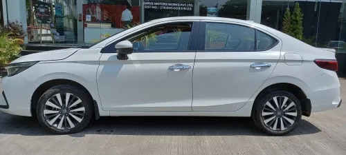 Honda City ZX CVT (Pre-Owned) – Garve Honda Auto Terrace, ChinchwadPremium Automatic Sedan | Low Mileage | Certified QualityExperience premium comfort and effortless driving with the Honda City ZX CVT, a well-maintained pre-owned sedan that perfectly blends luxury, advanced technology, and Honda's renowned reliability. Finished in the elegant Platinum White Pearl, this low-mileage vehicle is an ideal choice for those seeking a sophisticated automatic sedan.Vehicle Details:Model: Honda City ZX CVTManufacturing: March 2023Colour: Platinum White PearlKilometer Driven: 11,163 kmTransmission: Automatic (CVT)Fuel Type: PetrolPrice: ₹13,00,000/-Key Highlights:✅ Top-End ZX CVT Variant✅ Elegant Platinum White Pearl Finish✅ Only 11,163 km Driven✅ 1.5L i-VTEC Petrol Engine✅ Smooth & Fuel-Efficient CVT Automatic Transmission✅ Electric Sunroof✅ Premium Leather Upholstery✅ LED Headlamps with LED DRLs✅ 8-inch Touchscreen Infotainment System✅ Wireless Apple CarPlay & Android Auto✅ Honda LaneWatch™ Camera✅ Automatic Climate Control✅ Push Button Start/Stop✅ 6 Airbags, ABS with EBD & Vehicle Stability Assist (VSA)Why Choose This Honda City ZX CVT?Designed for effortless city driving and comfortable highway cruising, the Honda City ZX CVT delivers a refined automatic driving experience with impressive fuel efficiency, premium interiors, advanced safety features, and Honda's legendary reliability. It's the perfect sedan for professionals, families, and daily commuters.Why Buy from Garve Honda Auto Terrace, Chinchwad?✔ Honda Certified Pre-Owned Vehicle✔ Thorough Multi-Point Quality Inspection✔ Verified Vehicle History✔ Attractive Finance & EMI Options✔ Exchange Assistance Available✔ Hassle-Free Documentation✔ Trusted Honda Dealership✔ Reliable After-Sales SupportBuy a certified pre-owned Honda City ZX CVT (March 2023) in Platinum White Pearl from Garve Honda Auto Terrace, Chinchwad. Only 11,163 km driven. Available for ₹13,00,000. Enquire today!Used Honda City ZX CVT Chinchwad, Honda City ZX Automatic Pune, Honda City CVT Price Pune, Honda City Platinum White Pearl, Pre-Owned Honda City Automatic Pune, Certified Honda City Used Car Chinchwad, Honda City 2023 Model Pune, Honda City Low Mileage Pune, Honda City Automatic for Sale PCMC, Honda City ZX CVT Petrol Pune, Honda City Second Hand Chinchwad, Honda City Auto Terrace Chinchwad, Honda Certified Used Cars Pune, Honda City Automatic Sedan Pune, Best Used Honda City CVT Pune, Garve Honda Auto Terrace Used Cars, Honda City ZX CVT Price Pune, Used Honda Cars PCMC, Honda City Automatic Near Chinchwad, Honda City Premium Sedan Pune.