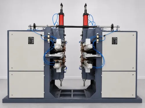 100 kVA + 100 kVA Pneumatic Dual Seam Welding machine for power transformer radiator Seam welding Machine with MFAC 2 Control Panel & 1 Synchronous Panel.The full seam body is hot spray galvanized. * Both m/c with separate A/C drive from Danfoss brand, the whole m/c is standard.* Input supply: 3-phase 415 volt AC/50 Hz line current approx. 80 Amp average* We provide a 180 Amp MCCB with a Control Panel - Indramani Associates make.* Output: 2-phase line current approx. 180 Amp average* Complete m/c & Controller design @ 50% Duty CycleBoth m/c will have silver housing for longer life & maintenance-free working. Only daily greasing is required.NOTE:1. Control Panel & Silver Housing need a chilling water supply. [Chiller requirement under customer's scope: 1000L tank, 3 Ton Chiller plant for dual seam]2. Rest of the m/c Transformer internal water cooling & welding wheel free flow water supply by separate room temperature water. (Cooling tower water)3. All water should be soft, clean water to protect from scaling.4. We provide the best quality machine with knurling drive at the top welding wheel & bottom only knurling self-drive.