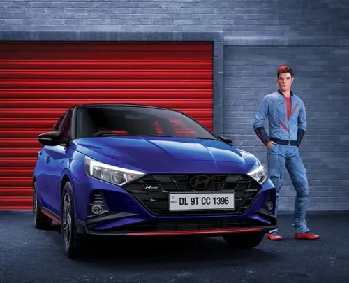 The Hyundai i20 N Line is a premium performance hatchback that combines Hyundai's motorsport-inspired engineering with bold styling, exhilarating performance, advanced technology, and intelligent safety. Designed for driving enthusiasts who seek excitement without compromising on comfort or practicality, the Hyundai i20 N Line delivers a thrilling driving experience every time you get behind the wheel. Available at Ketan Hyundai, Amravati, the Hyundai i20 N Line offers the perfect balance of sporty performance, premium features, and everyday usability.
Inspired by Hyundai's global N performance division, the Hyundai i20 N Line features exclusive design enhancements, a powerful turbocharged engine, sport-tuned suspension, and advanced connectivity, making it one of the most exciting premium hatchbacks in India.
The Hyundai i20 N Line stands out with its aggressive and athletic exterior styling. Exclusive N Line design elements include a signature cascading front grille with N Line badging, sporty front and rear bumpers, red accents across the body, dual-tip chrome exhaust, side skirts, 16-inch diamond-cut alloy wheels, LED projector headlamps, Z-shaped LED Daytime Running Lamps (DRLs), LED tail lamps, shark-fin antenna, and aerodynamic body lines. Every design detail enhances its sporty appeal while maintaining Hyundai's premium craftsmanship.
Inside the cabin, the Hyundai i20 N Line offers a sporty yet luxurious interior. The all-black cabin with bold red accents, N Line leatherette seats, red contrast stitching, N-branded steering wheel, leather-wrapped gear lever, metal pedals, ambient lighting, and premium soft-touch materials create an exciting driving environment. The spacious cabin provides excellent comfort, generous legroom, and a practical boot, making it suitable for both daily commutes and weekend adventures.
The Hyundai i20 N Line is powered by Hyundai's 1.0L Turbo GDi Petrol Engine, delivering responsive acceleration, refined performance, and impressive fuel efficiency. The turbocharged engine ensures spirited driving while maintaining smooth power delivery in city traffic and on highways.
Transmission options include:
6-Speed Intelligent Manual Transmission (iMT)
7-Speed Dual Clutch Transmission (7DCT)
These transmission choices provide quick gear changes, seamless acceleration, and a highly engaging driving experience.
To enhance driving dynamics, the Hyundai i20 N Line features several performance-focused upgrades, including:
Sport-Tuned Suspension
Three Drive Modes (variant dependent)
Paddle Shifters (7DCT Variant)
Sharper Steering Response
Enhanced Cornering Stability
Performance-Tuned Exhaust Note
Improved Ride and Handling
These upgrades deliver a more connected and enjoyable driving experience while preserving everyday comfort.
The Hyundai i20 N Line is equipped with Hyundai's latest premium technology, ensuring superior convenience and connectivity.